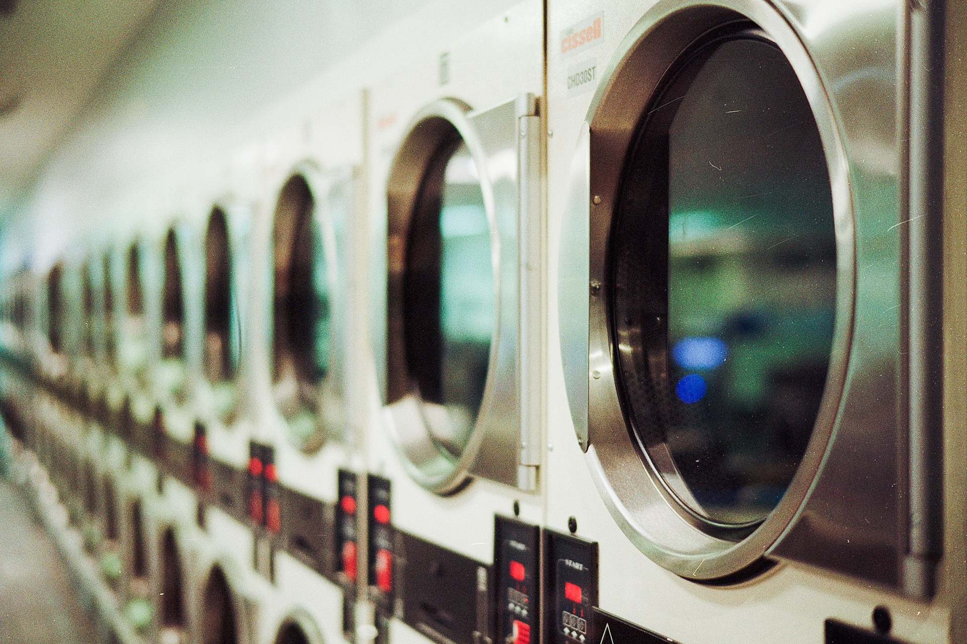 A row of commercial laundry machines
